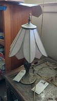 Full view of stained glass table lamp on table