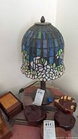 Full view stained glass table lamp on table