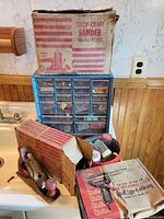 Overview showing Shop-Craft sander box, hardware organizer, jars, hand plane