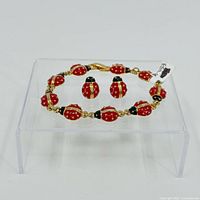 Bracelet and earrings front view showing ladybug motif