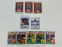 Overview showing all sealed packs and two autograph cards