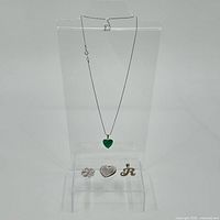Full view of necklace with malachite heart pendant and three additional silver charms below