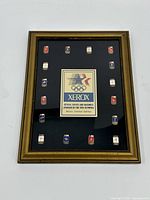 Front view of framed Xerox Olympic pin set