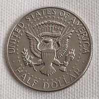 Reverse of 1968 Kennedy half dollar showing UNITED STATES OF AMERICA and HALF DOLLAR legends with heraldic eagle