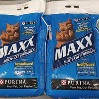 Two sealed 10 kg Purina MAXX cat litter bags side by side