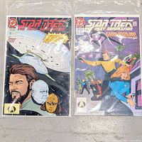 Both Star Trek TNG comic books in sleeves, covers visible