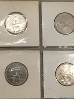 Close-up of four coins obverse and reverse detail