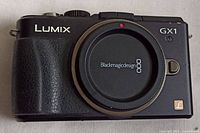 Front view of Panasonic Lumix GX1 body with body cap
