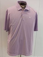 Full front view of lavender Nike polo shirt on mannequin