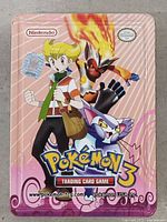 Front of pink Pokemon TCG metal tin
