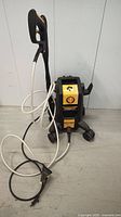 Full view of PowerPlay Spyder pressure washer with hose and spray gun