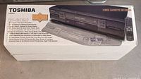 Retail box showing Toshiba W-602C VCR graphics and model details