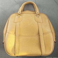 Front view of tan square travel bag with dual handles