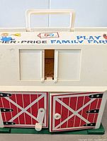 Front view showing barn doors, crank handle and top carry handle