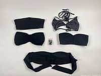 All five swimwear tops and bag of clips laid out