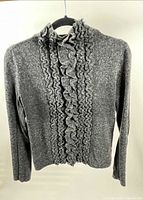 Front view of grey knit DKNY CITY sweater on hanger