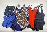 Group shot of all 11 swim pieces on white background