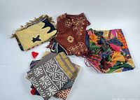 Group shot of all eight scarves and wraps showing variety of colors and patterns