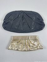 Front view of both clutches showing exterior colors and pleat details