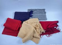 All five scarves laid out showing colors and styles