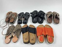 Group shot of all seven pairs of sandals and slip-ons