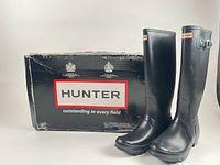 Boots standing upright beside Hunter branded box