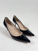 Pair of black patent leather heels, top and side view