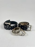 Group shot of two studded black belts and two white-band watches