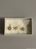 Stud earrings and pendant in box overview