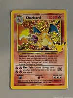 Front of Charizard Celebrations holographic card showing artwork, HP, moves, card number 4/102 and foil pattern