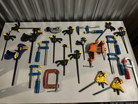 All clamps, vise, cutter and rivet gun laid out on table