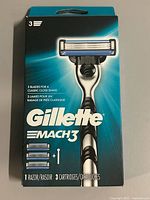 Front of sealed Gillette Mach3 package showing razor and cartridge count