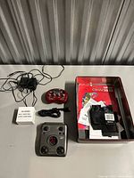 Full lot overview showing Pocket POD, Zoom G1 pedal, two power adapters, cable, red tin with contents