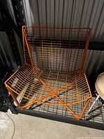 Front view of orange steel wire Skålboda chair