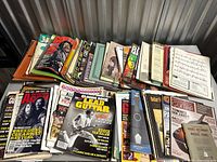 Overall view of multiple stacks of magazines, songbooks and sheet music