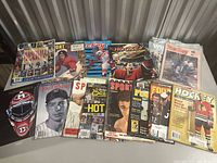 Group of assorted sports magazines spread on table