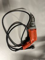 Full view of Milwaukee corded drill with cord