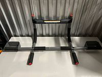 Front view of Perfect Fitness Multi-Gym pull-up bar on table