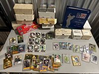 Overall view of table with boxed sets, storage boxes, binder, autographed cards displayed