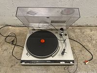 Front top view of Technics SL-3200 turntable showing dust cover, platter, tonearm and cables