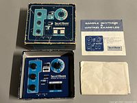 Drum machine with box, leaflet, and envelope laid out