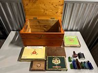 Overall view of pine chest, cigar boxes and glass bottles