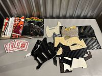 Overview of lot showing books, pickguards and string packets