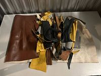 Pile of assorted leather scraps spread on a table