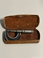 Micrometer inside open velvet-lined case