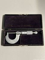 micrometer inside open velvet-lined case