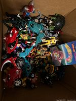 Overview of box with assorted action figures, motorcycles and packaged yo-yo