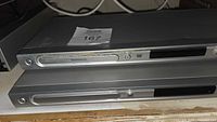 Two stacked slim Magnavox DVD players, front branding visible