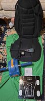 All three items laid out: ab roller, digital scale, HoMedics seat massager cushion with remote and adapter