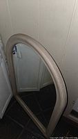 Front angled view showing full arched mirror with frame